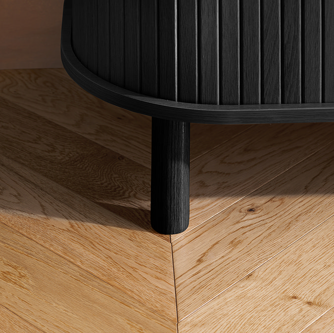 close up image of foot of black wooden fluted tv unit, on wooden floor