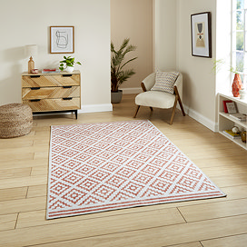 Coral rug in orange on floor image 1