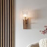 image of curved ribbed light shade with brass arm and dark beechwood backplate