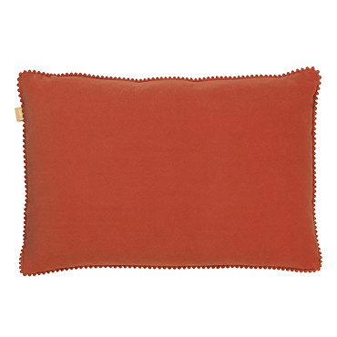 image cut out on white background of brick orange cushion with tiny pom-pom edging, on its side to show its plumpness