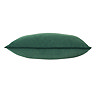 image cut out on white background of marine-green cushion edged with pompoms, on its side to show its plumpness