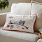 rectangular christmas cushion, cream with winter scene, sat on cream sofa