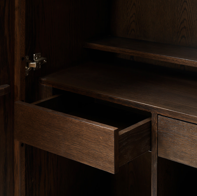 close up image on the inside of dark oak drinks cabinet with one of two inner drawers pulled out
