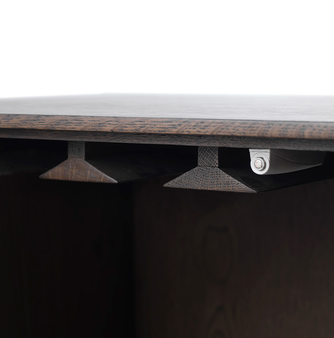 close up image of inside cabinet hinges where glasses can be hung from