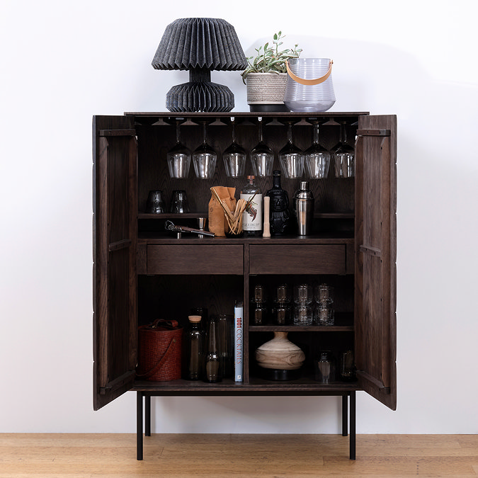 image of dark oak drinks cabinet with doors open, showing glasses and bottles inside on spacious shelving