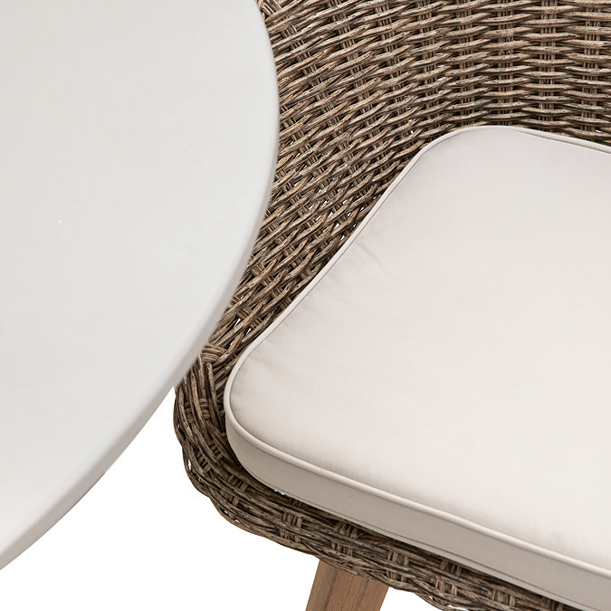 close up image of plush cream chair seat of wicker chairs