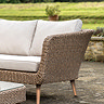 close up on wicker arm and plush cushions of corner lounge set