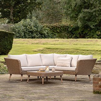 image of wicker outdoor corner lounge set with glass-top table