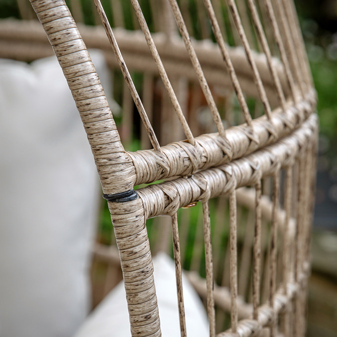 close up image on wicker frame of rounded garden egg chair