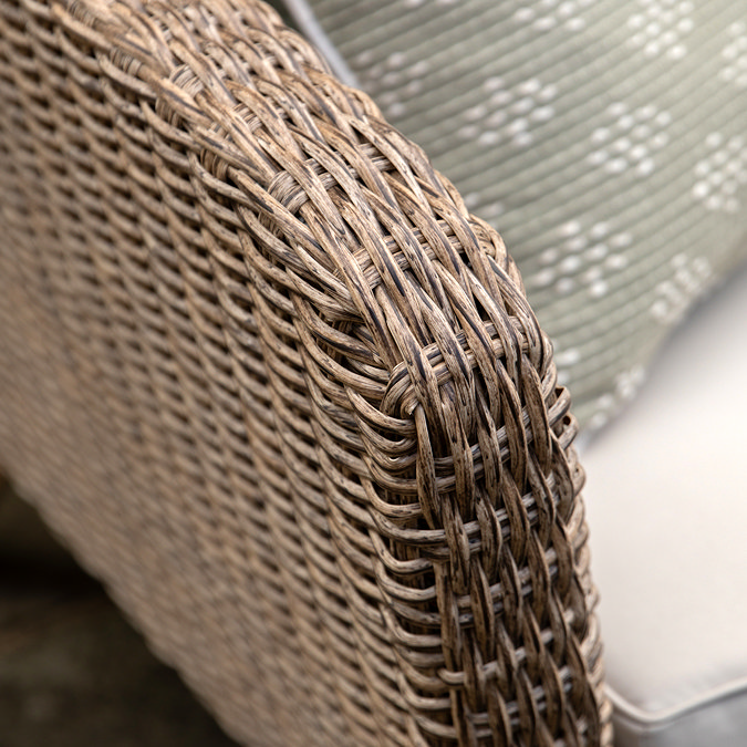close up on brown wicker arm of outdoor chair