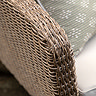 close up on brown wicker arm of outdoor chair