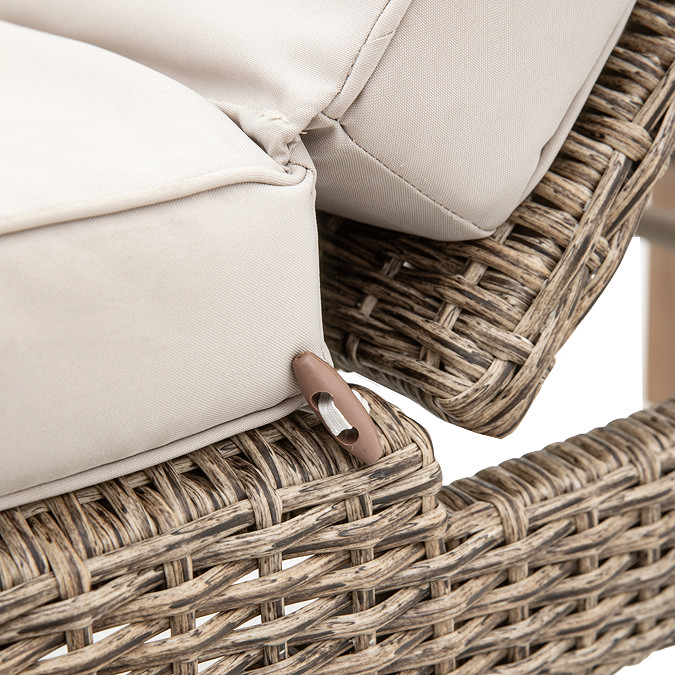 close up image of plush cream cushion of wicker sun lounger