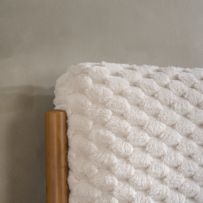 close up image of faux fur bubble effect headboard of double bed