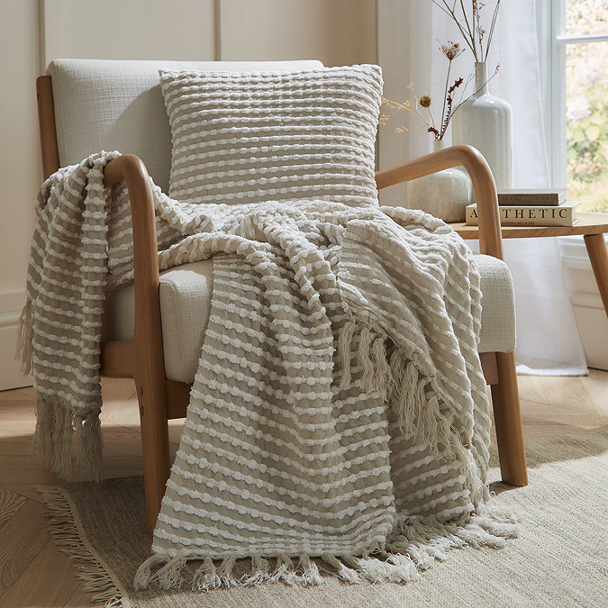 Darby Embroidered Cushion Natural Front View on Chair With Throw