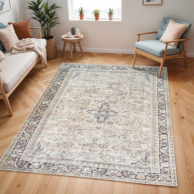 image of vintage floral rug with shades of grey, mauve and brown, on light wood flooring of modern apartment