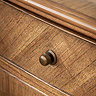 close up image on mindi wood finish of sideboard, with bronze beehive pull handles on the drawer