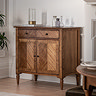 image of mindi wood sideboard with 2 doors and 1 drawer, against a cream wall and topped with decorative accessories