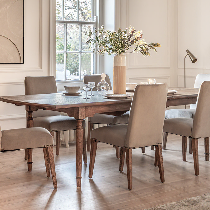 image of rectangular dining table extended to show space for more chairs, on wooden flooring of dining room