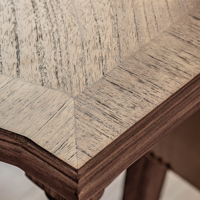 close up image on corner of rectangular mindi wood dining table