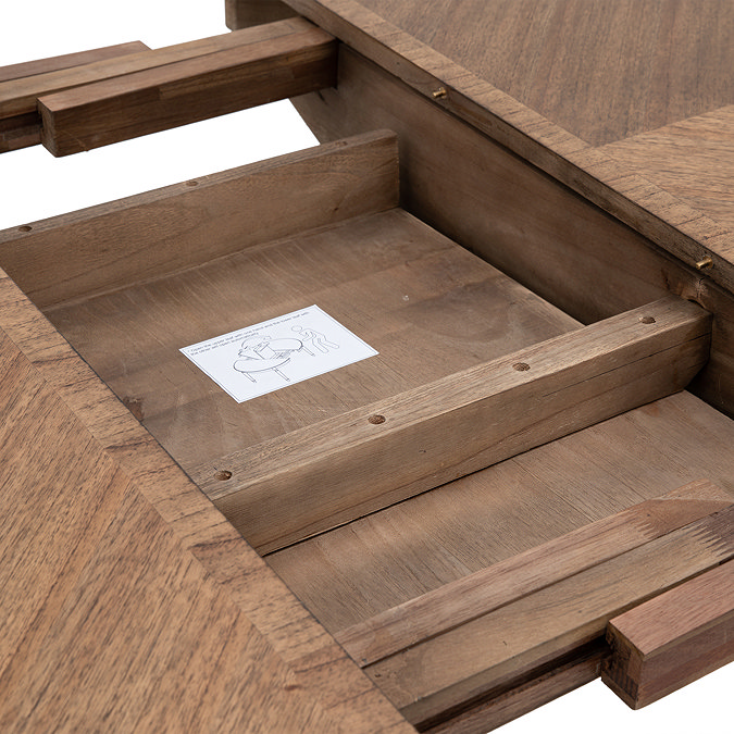 close up image of round dining table where it can be extended to seat more people
