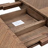 close up image of round dining table where it can be extended to seat more people