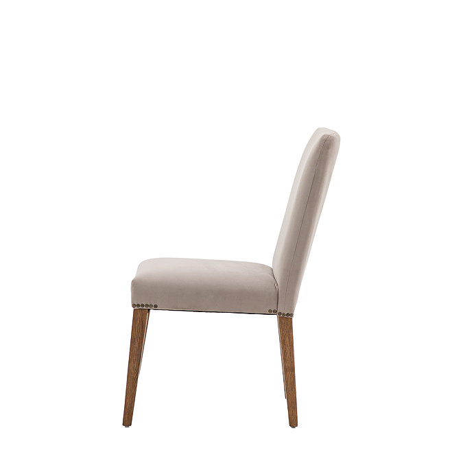 side on image cut out on white background of grey upholstered dining chair