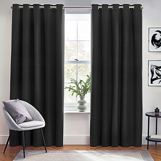 Pair of black curtains over a window image 1