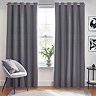 Charcoal grey curtains open in front of living room window.