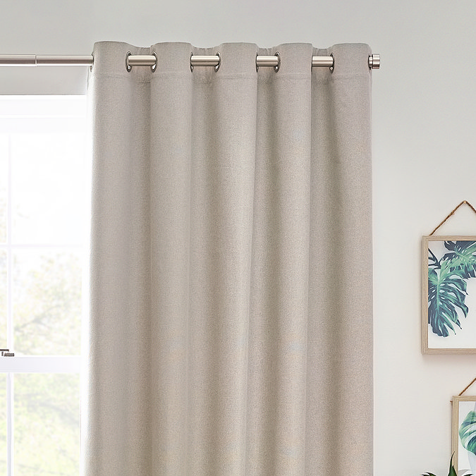Close up of linen coloured curtains in eyelet style