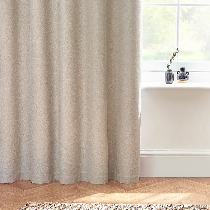 Close up on linen coloured curtains brushing the wooden floor.