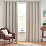 Floor length linen coloured curtains open across a living room window