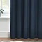 Close up of dark blue curtains brushing the floor