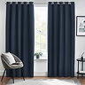 Midnight blue floor length curtains open in front of a window