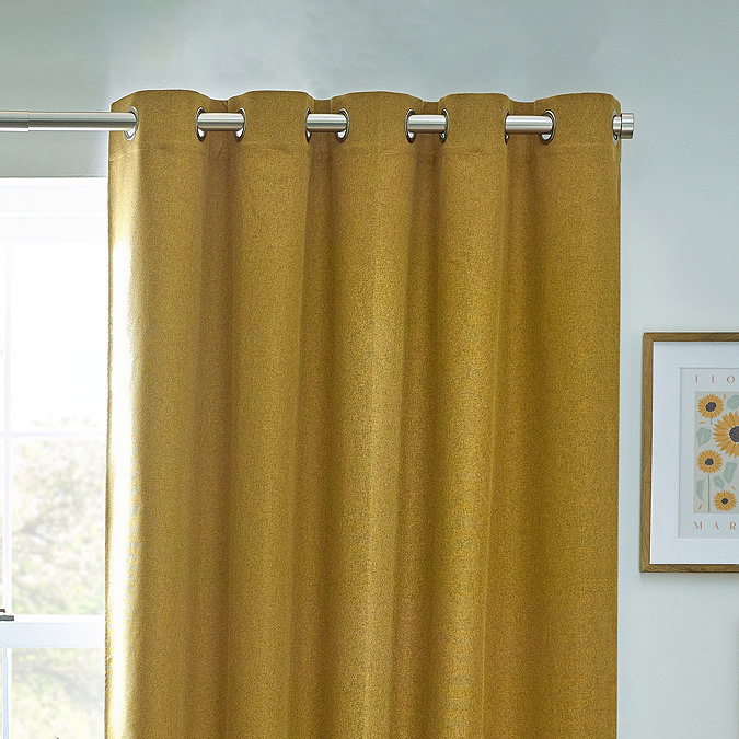 Close up of mustard curtains in eyelet style