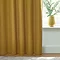 Close up of mustard curtain brushing the floor