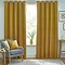 Floor length mustard curtains open in front of window