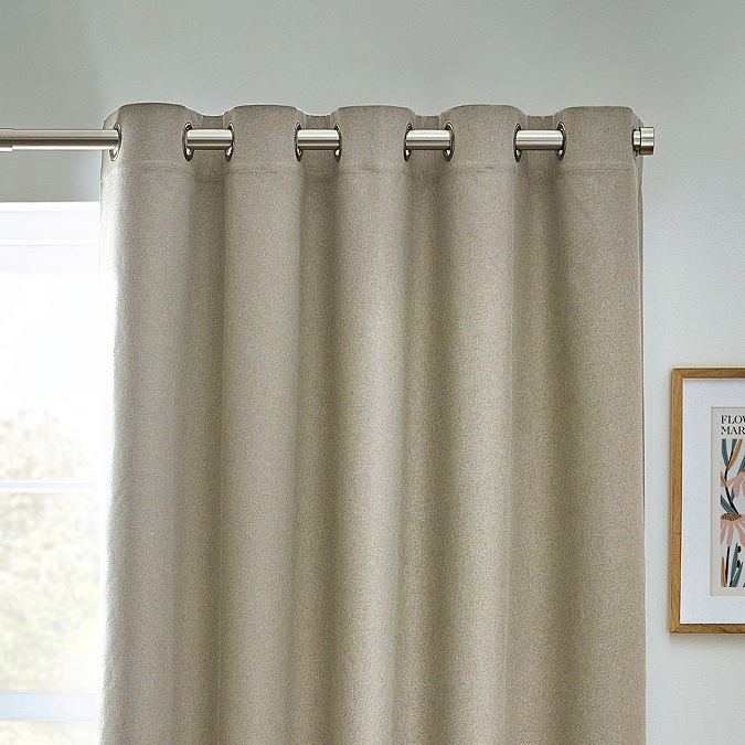 Close up of natural coloured curtains in eyelet style