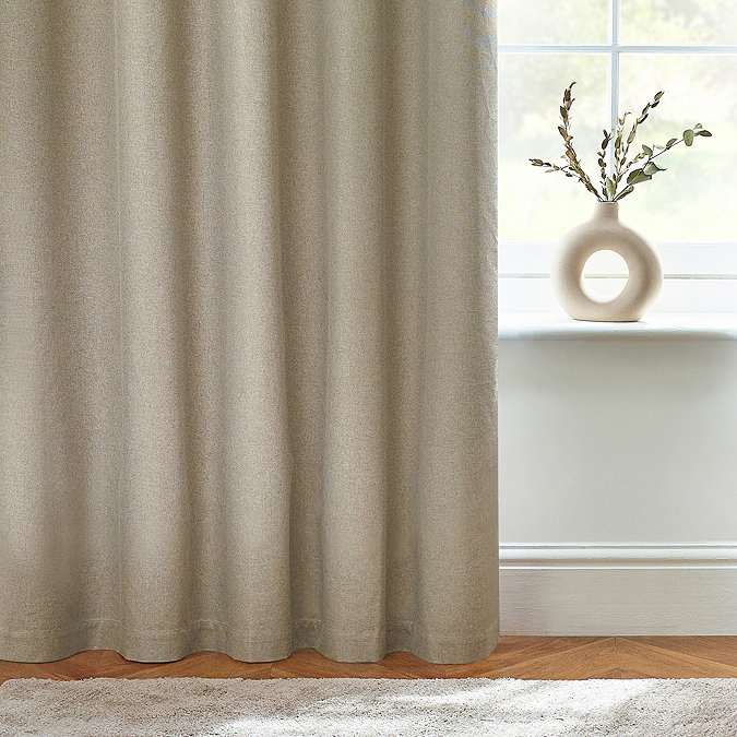 Close up of natural coloured curtain brushing the floor