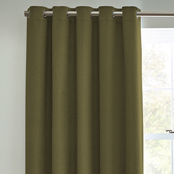 Close up of olive green curtains in eyelet style