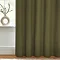 Close up of olive green curtains brushing the floor