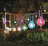 image of multi coloured string lights, set of 10, lit up at night outside a house