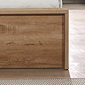 close up image on wooden footboard of storage bed