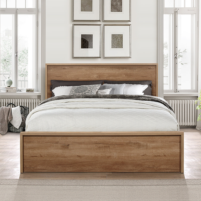 front-on image of sturdy rustic oak bed against cream wall