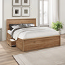 image of sturdy rustic oak bed pushed against cream wall with side drawer pulled out