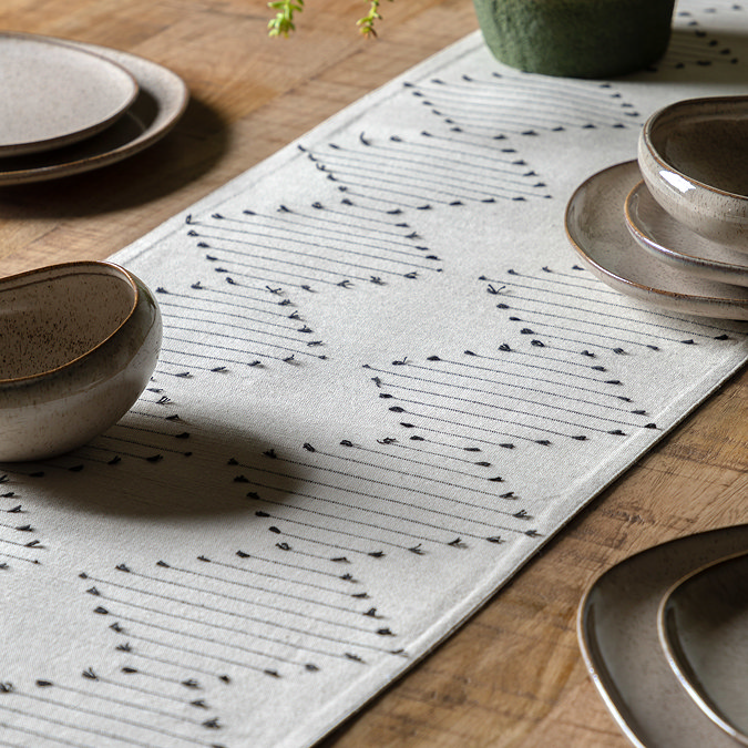 image of linen coloured table runner with diamond weave pattern on oak dining table 