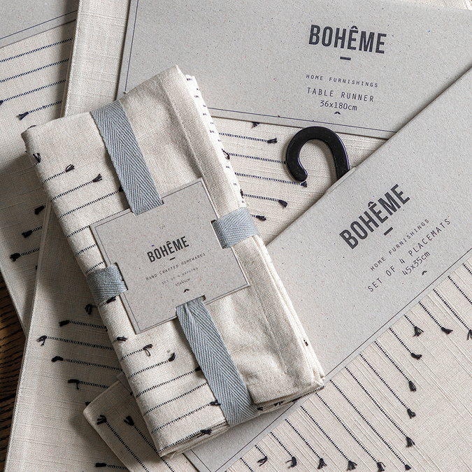 image of packaged linen napkins wrapped in light blue ribbon with brand on front