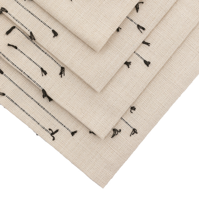 image cut out on white background of corner of linen embroidered napkin