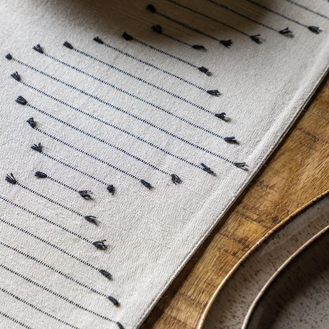 close up image of diamond weave pattern in natural coloured table runner