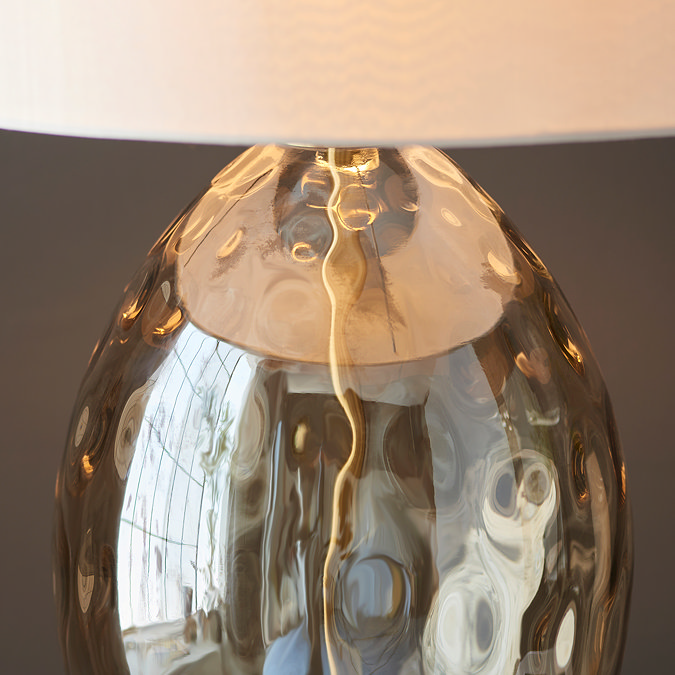 close up image of dimpled champagne gold body of table lamp