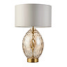 image cut out on white background of champagne gold dimpled table lamp